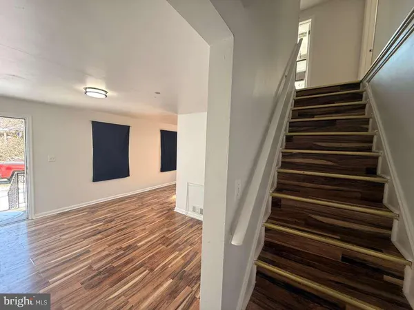 a view of an entryway with wooden floor