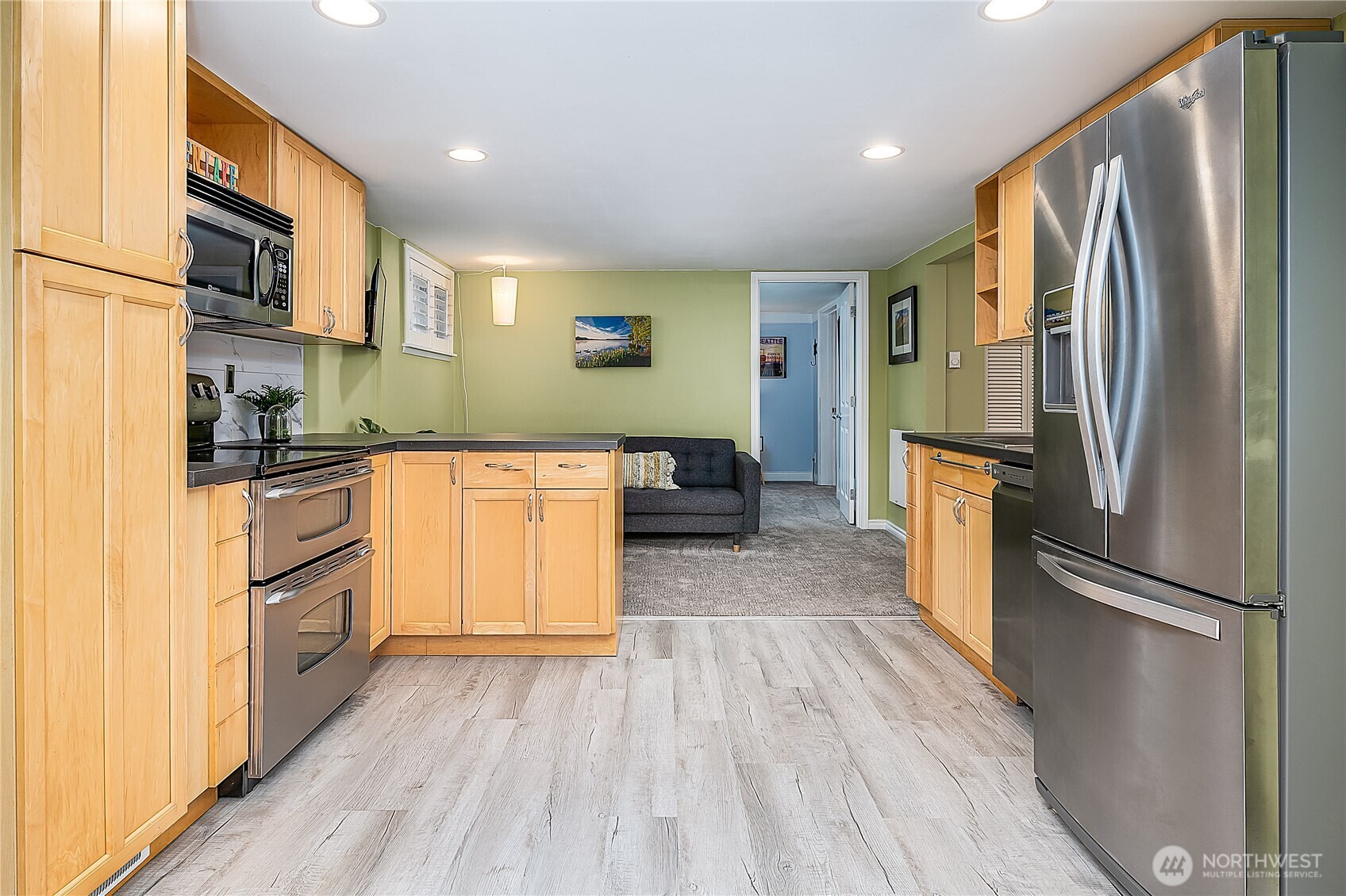 7638 Winona Avenue North, Unit B Seattle, WA 98103 - Photo 19 of 20 a kitchen with a refrigerator stove and wooden floor