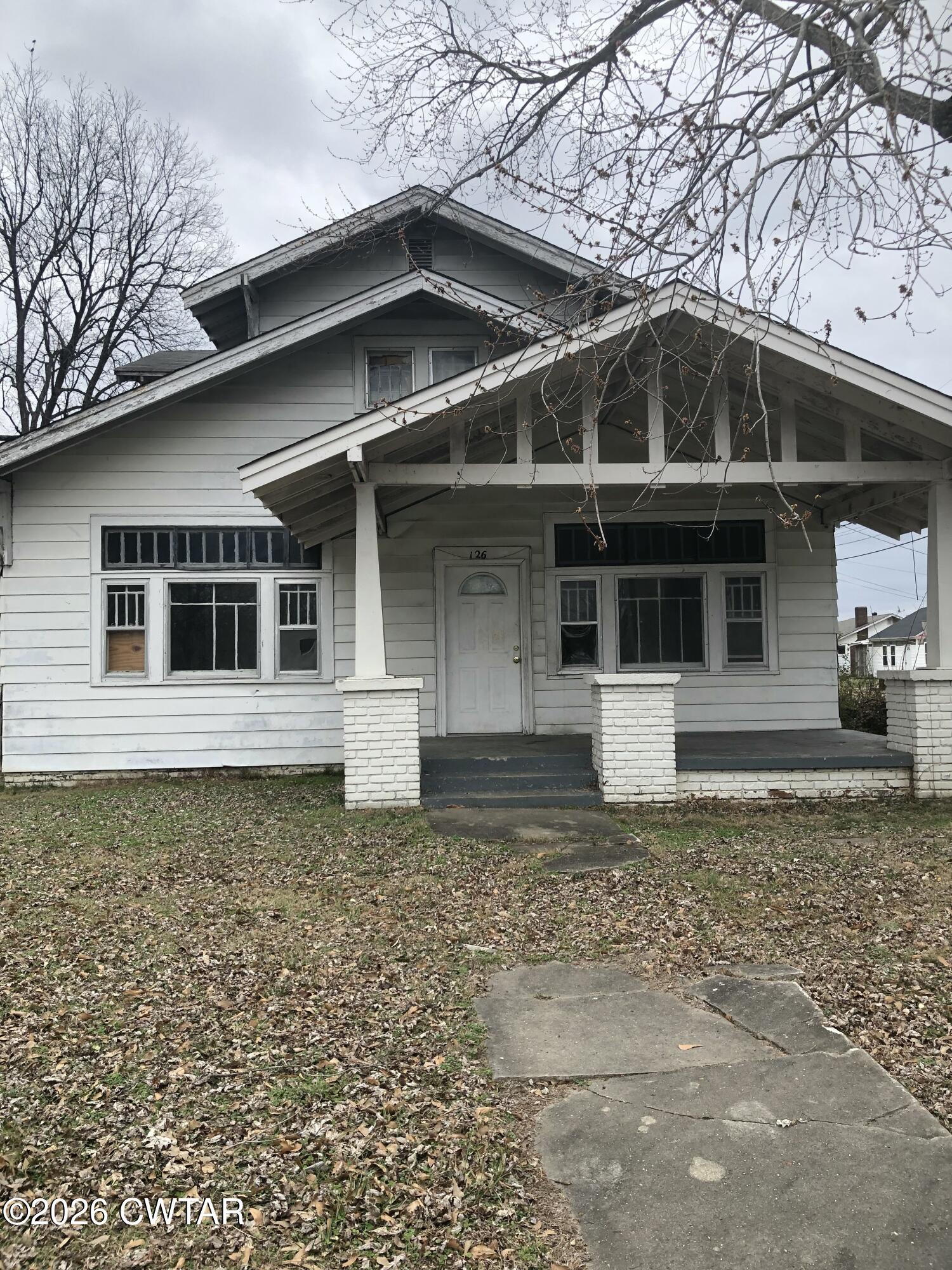 126 McCorry Street Jackson, TN 38301 - Photo 1 of 8 a front view of a house with a yard