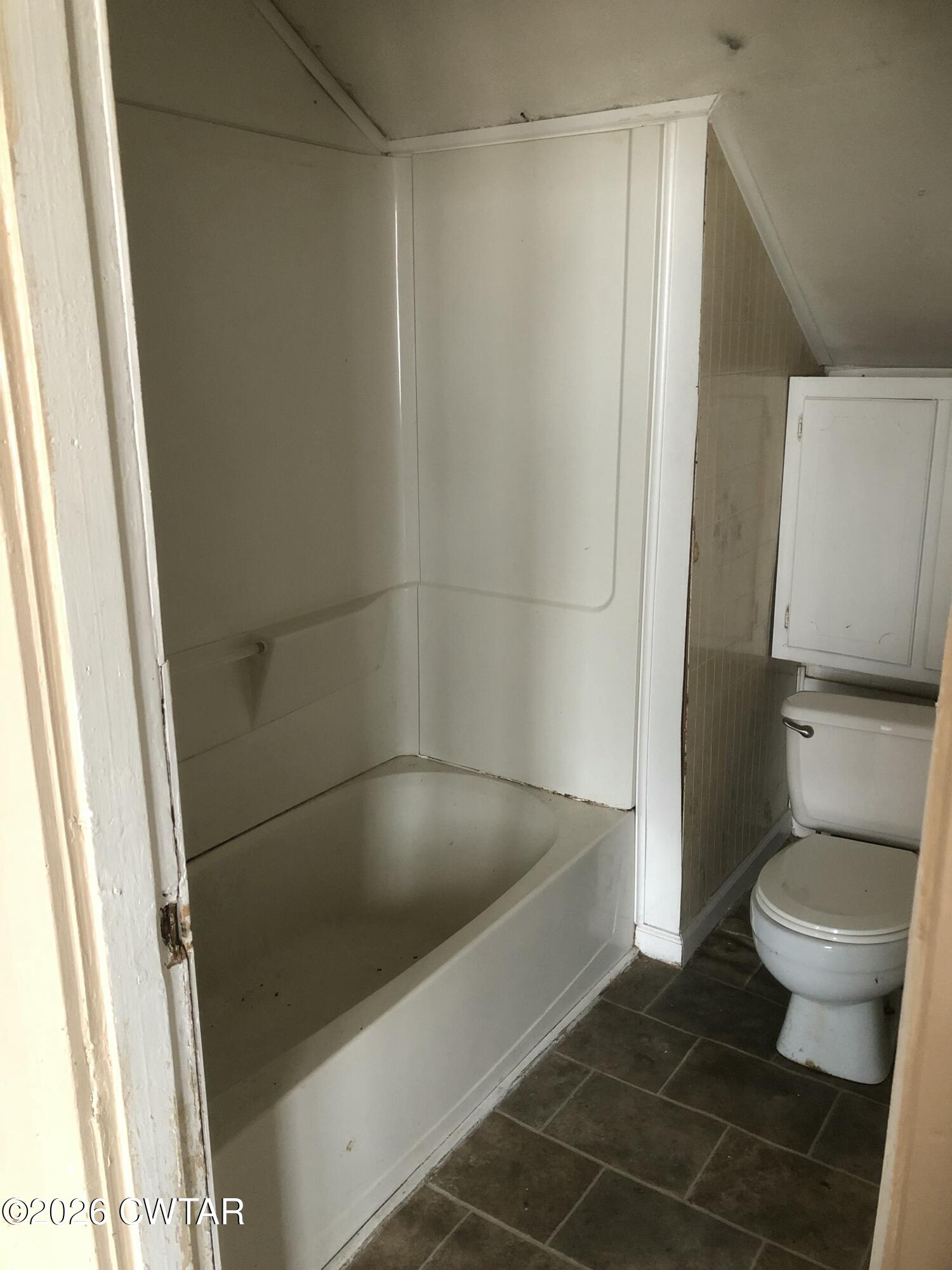 126 McCorry Street Jackson, TN 38301 - Photo 7 of 8 a bath room with a toilet and a shower