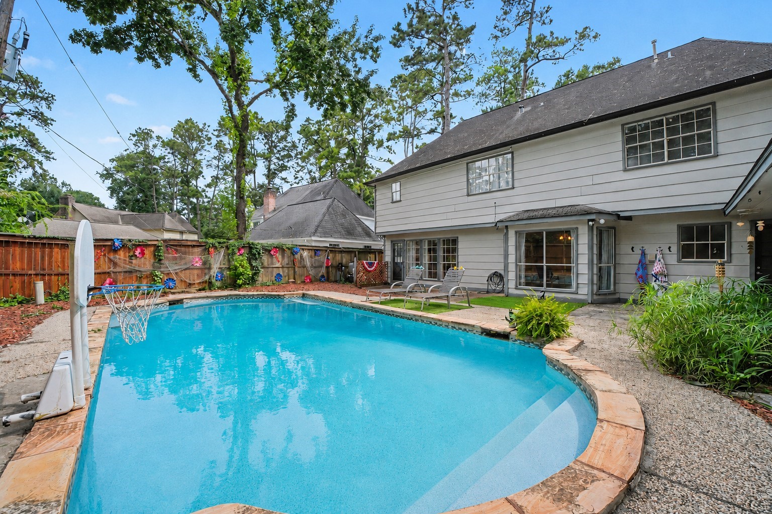 9530 Arcade Drive Spring, TX 77379 - Photo 27 of 32 Step outside to the backyard featuring a sparkling pool with an impressive 13-foot depth, perfect for summer fun and entertaining.