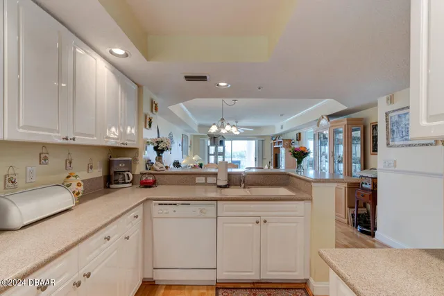a kitchen with stainless steel appliances kitchen island granite countertop a sink and cabinets