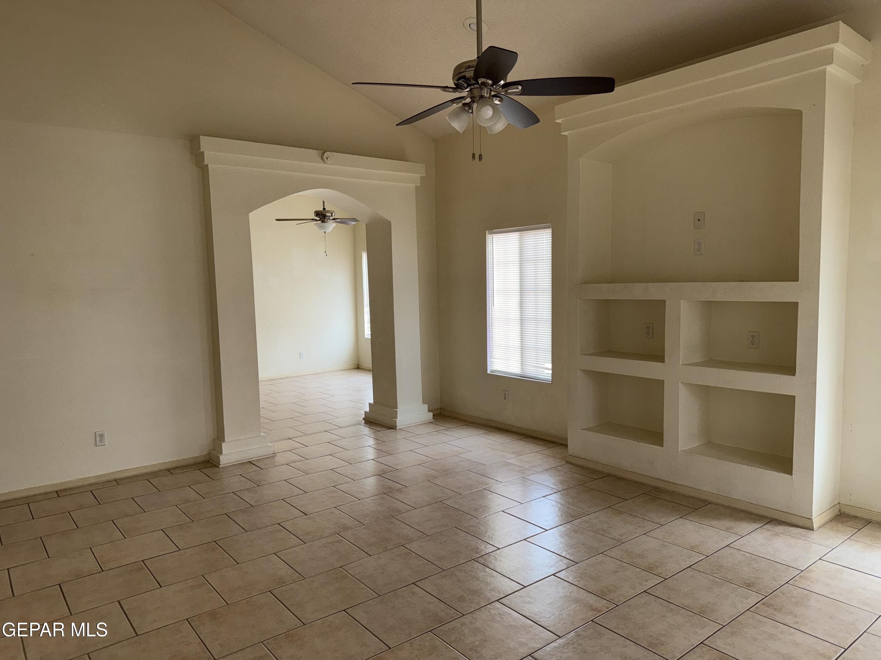 456 Passmore Road Socorro, TX 79927 - Photo 7 of 23 a view of a livingroom with a ceiling fan and window