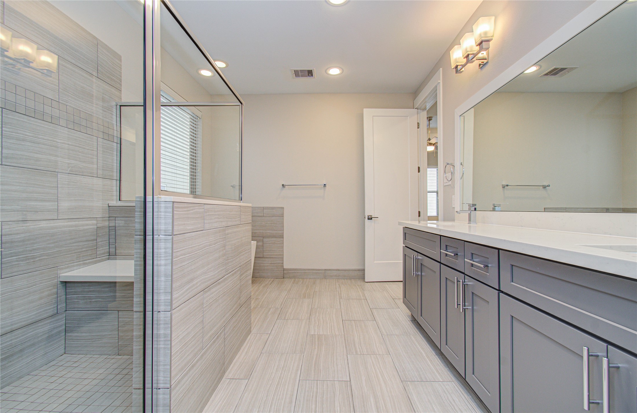 3516 Bastrop Street Houston, TX 77004 - Photo 17 of 25 a bathroom with a double vanity sink a toilet and a mirror