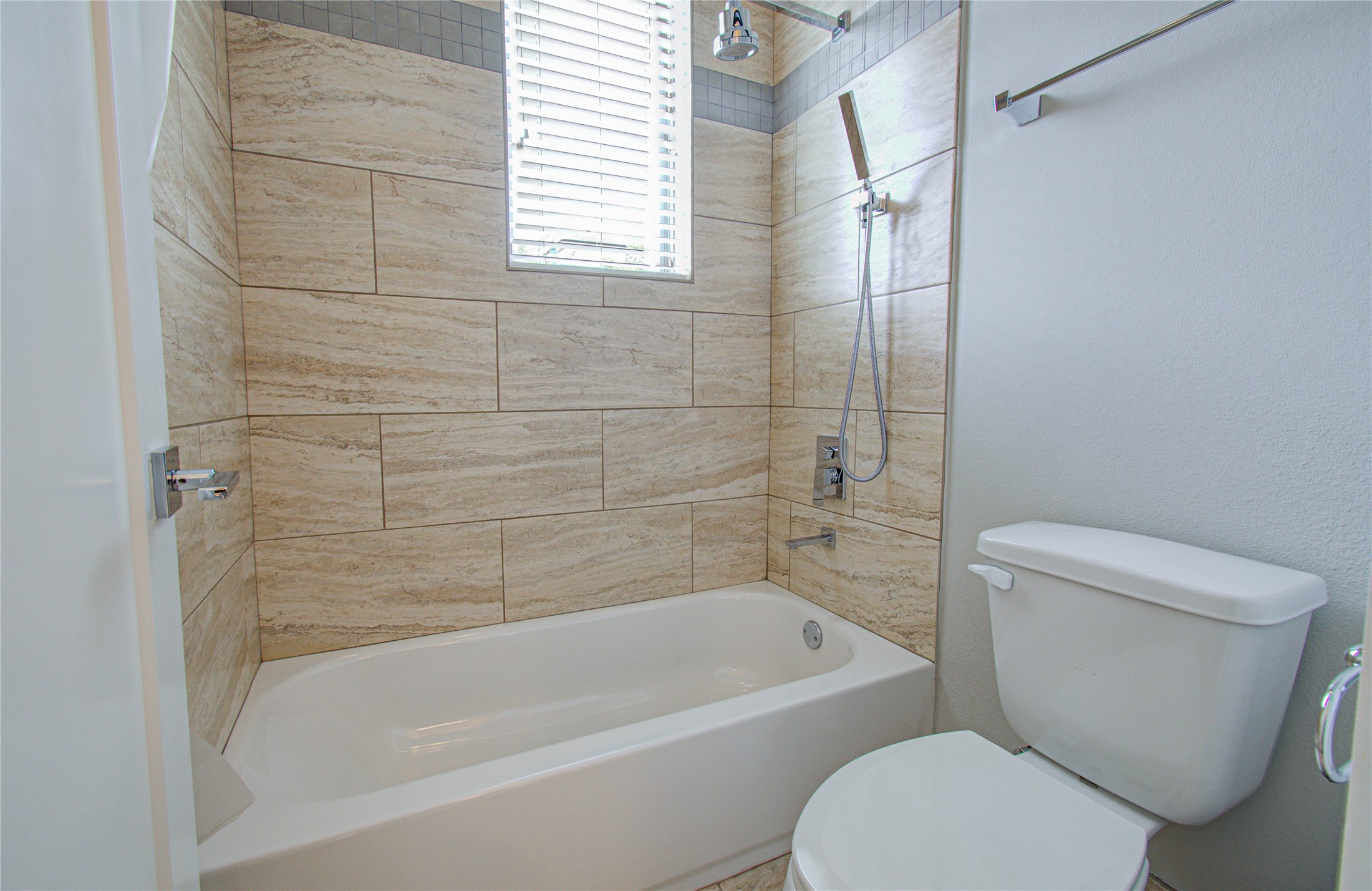 3516 Bastrop Street Houston, TX 77004 - Photo 22 of 25 a white toilet and tub sitting next to a window