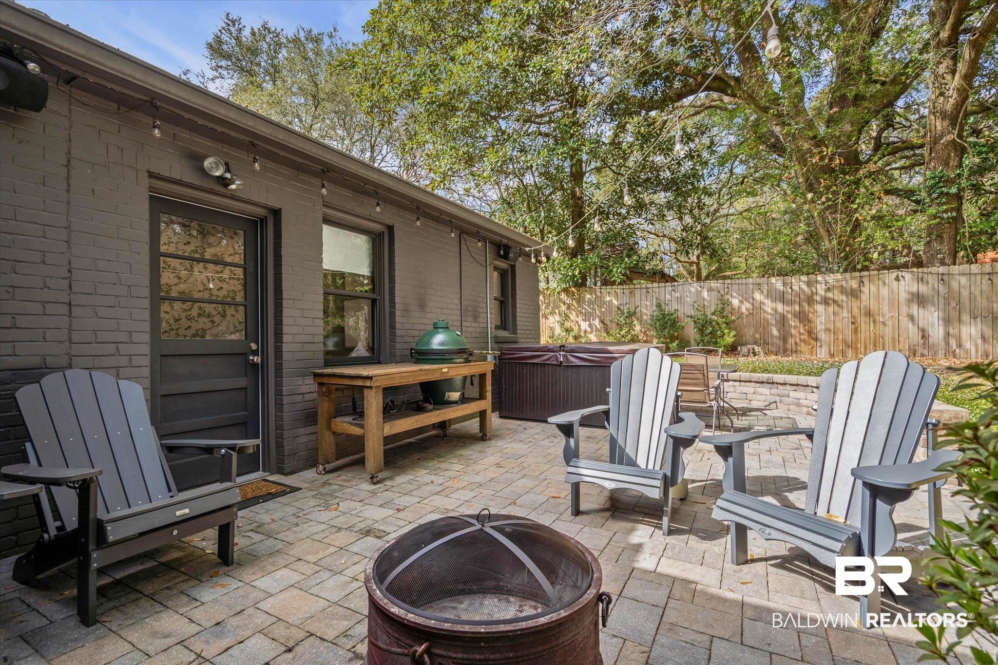4590 Sunset Drive North Mobile, AL 36608 - Photo 13 of 35 View of patio / terrace featuring a hot tub and a fire pit