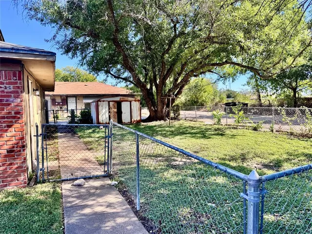 a view of a house with yard and sitting area