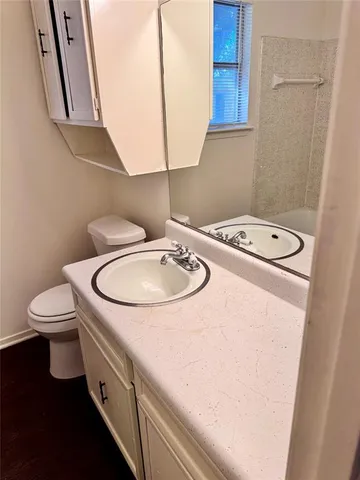 a bathroom with a sink a toilet and a mirror