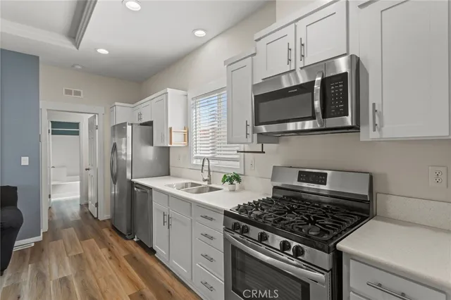 a kitchen with stainless steel appliances granite countertop a stove and a microwave
