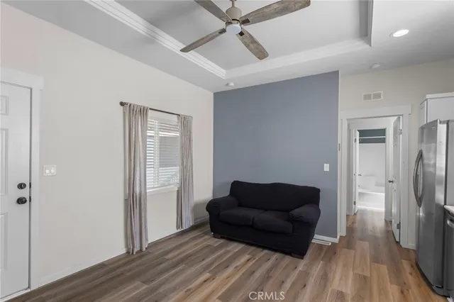 a living room with furniture and a wooden floor