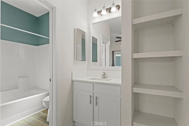 a bathroom with a bathtub sink vanity and mirror