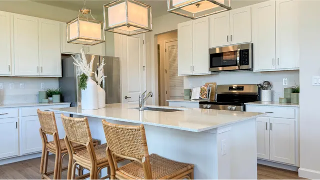 a kitchen with stainless steel appliances granite countertop a sink a stove and a refrigerator