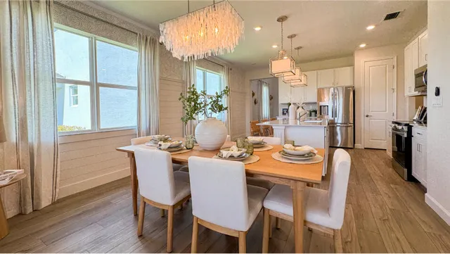 a dining room with furniture window and wooden floor