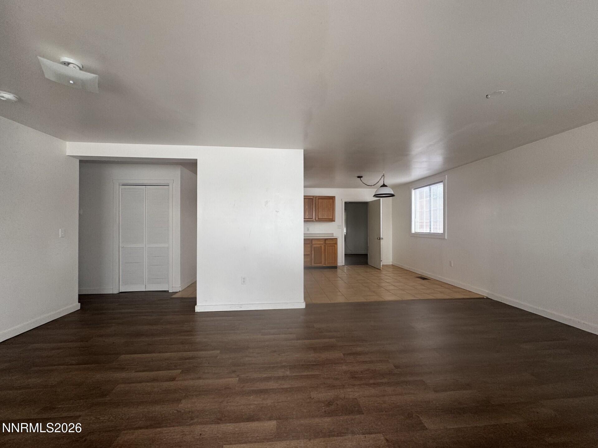 7533 Sandhill Road Fallon, NV 89406 - Photo 4 of 19 an empty room with wooden floor and windows