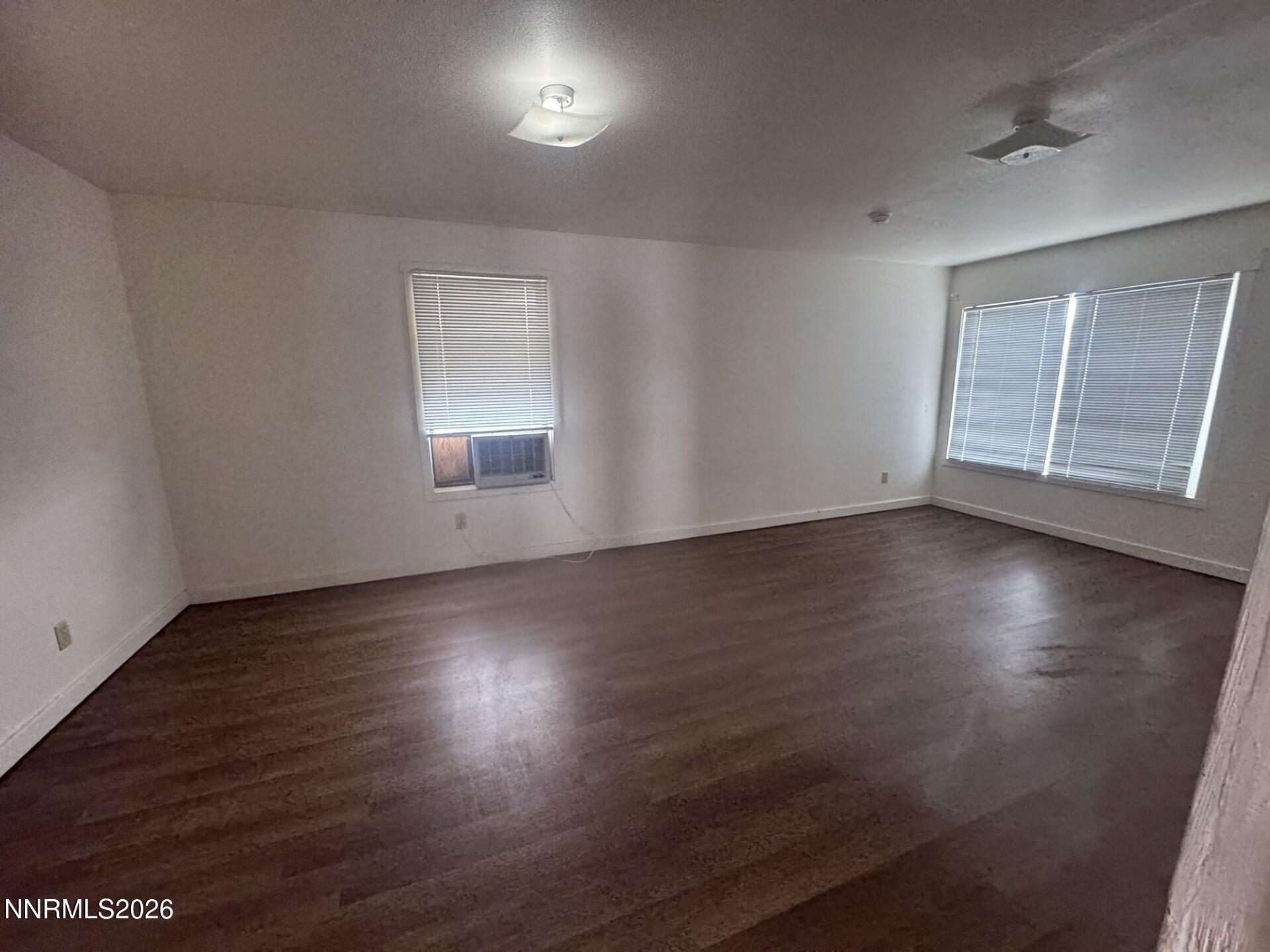 7533 Sandhill Road Fallon, NV 89406 - Photo 9 of 19 an empty room with wooden floor and windows