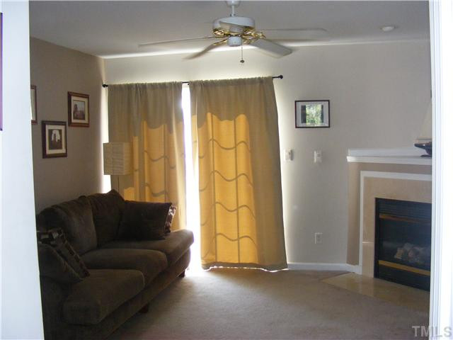 4901 Windproof Way Raleigh, NC 27616 - Photo 3 of 15 a living room with furniture and a fireplace