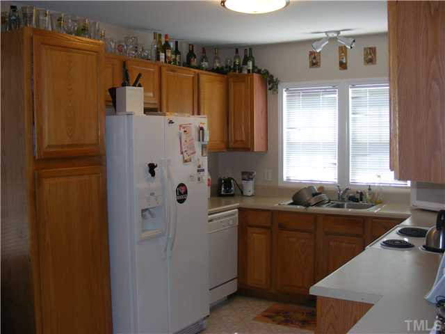 4901 Windproof Way Raleigh, NC 27616 - Photo 4 of 15 a kitchen with a sink a refrigerator and window