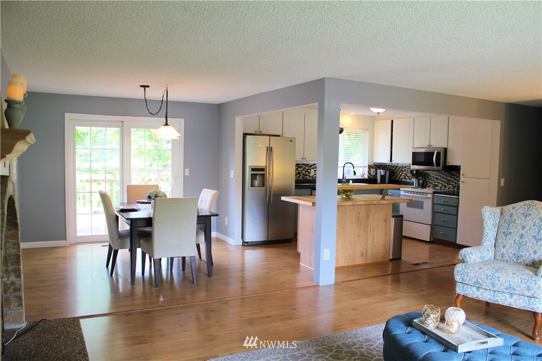 709 222nd Street Southwest Bothell, WA 98021 - Photo 12 of 38 a living room with couches chairs kitchen view and a large window