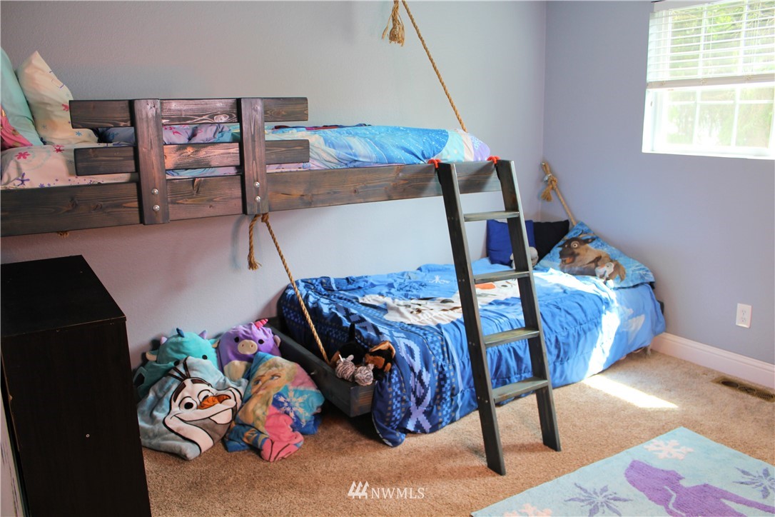 709 222nd Street Southwest Bothell, WA 98021 - Photo 16 of 38 a bedroom with furniture and a wooden floor