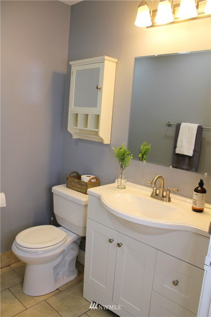 709 222nd Street Southwest Bothell, WA 98021 - Photo 24 of 38 a bathroom with a granite countertop toilet sink and mirror