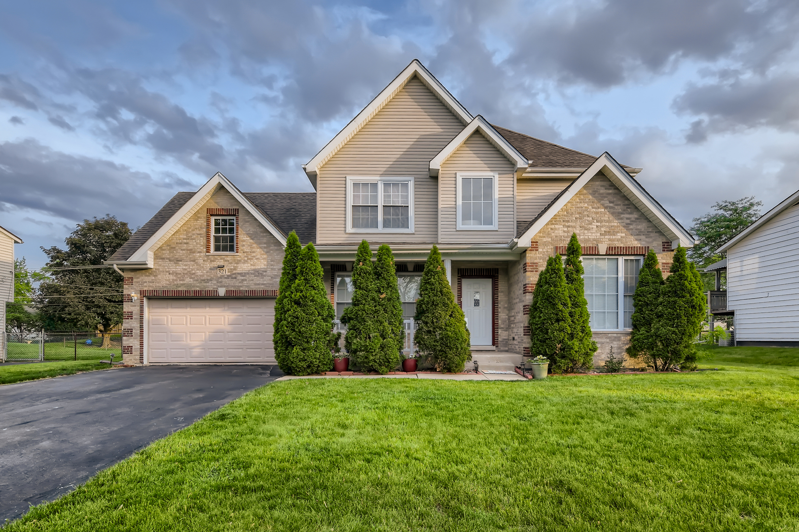 321 Rockhurst Road Bolingbrook, IL 60440 - Photo 1 of 21 a front view of a house with a yard and garage