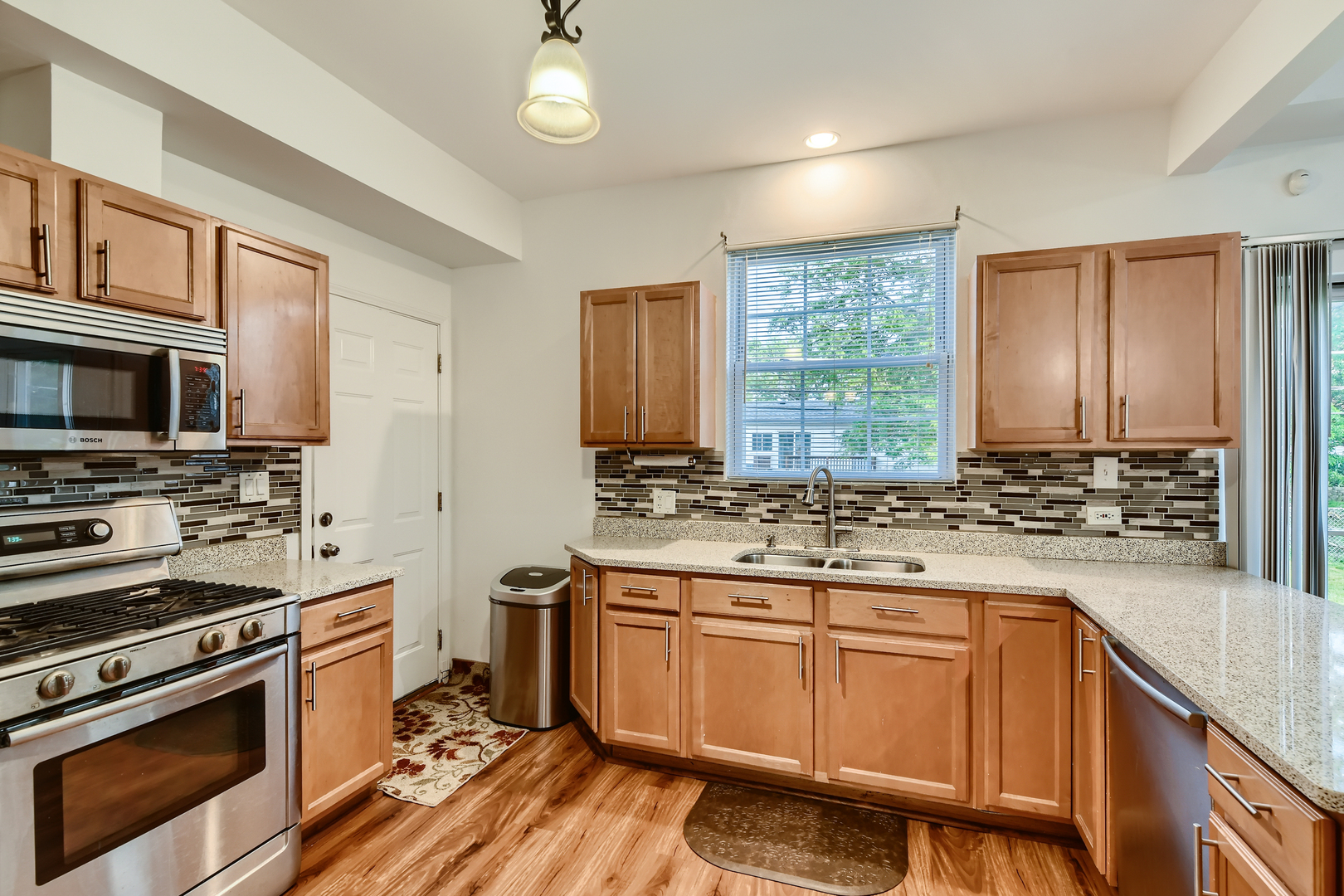 321 Rockhurst Road Bolingbrook, IL 60440 - Photo 7 of 21 a kitchen with a stove a sink and a microwave