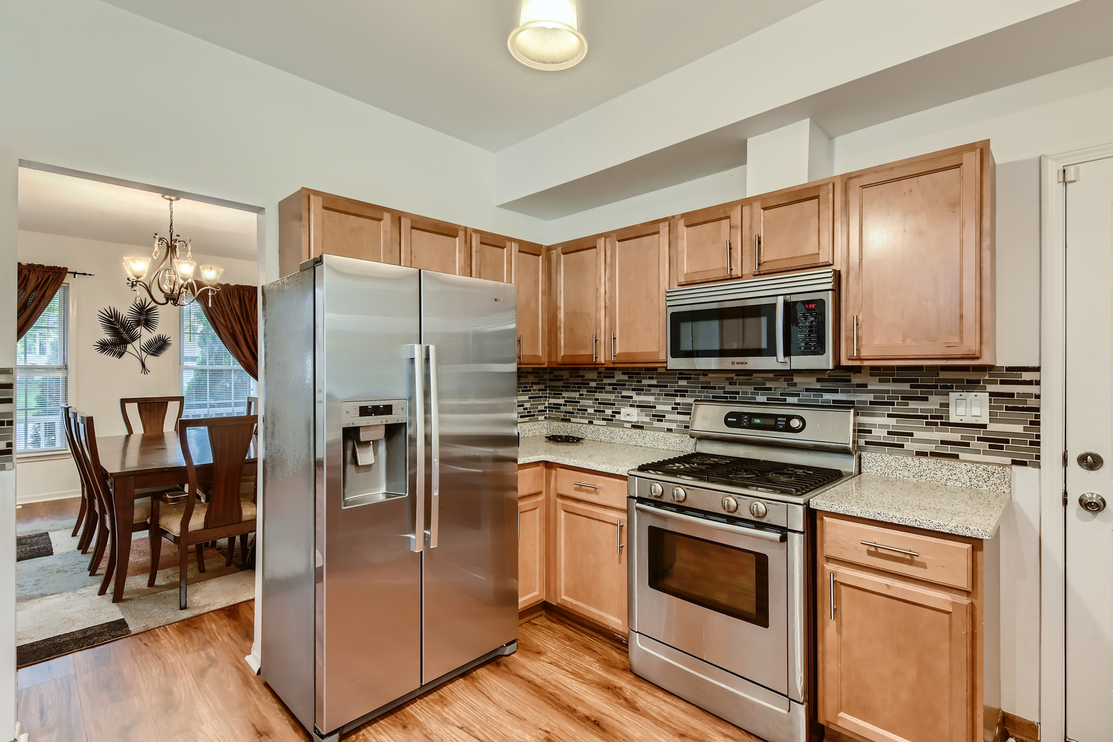 321 Rockhurst Road Bolingbrook, IL 60440 - Photo 8 of 21 a kitchen with stainless steel appliances a refrigerator stove and microwave
