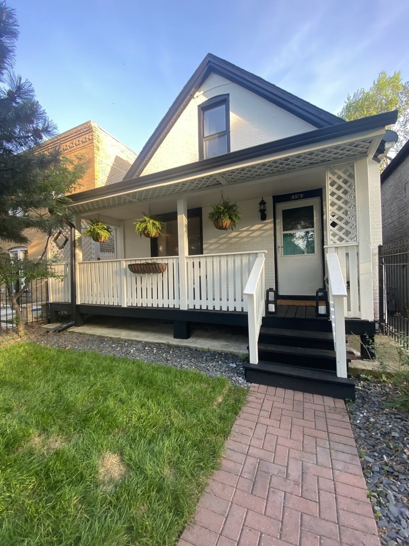 a front view of a house with a garden