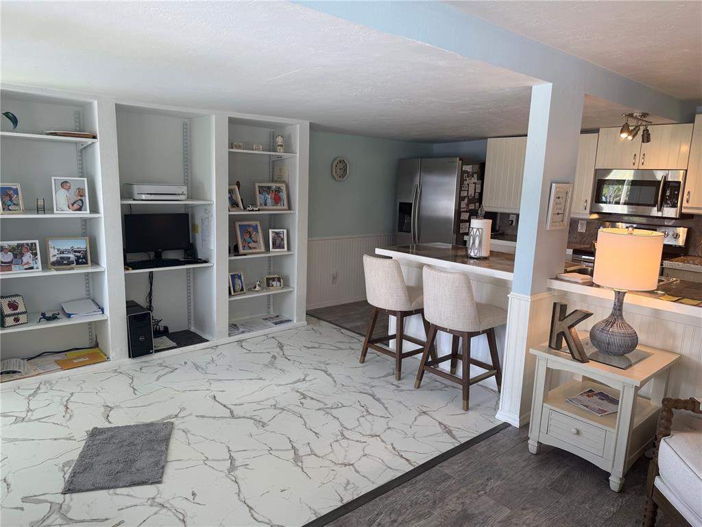 6190 Daffodil Road Venice, FL 34293 - Photo 6 of 22 a living room with furniture and a flat screen tv