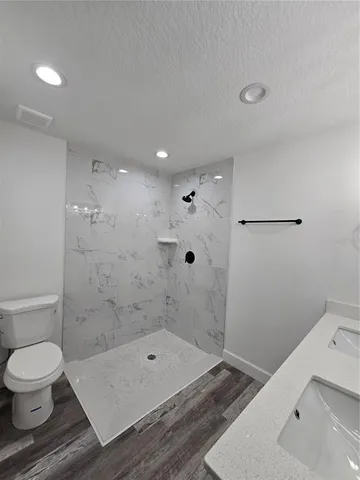 a bathroom with a toilet and a shower