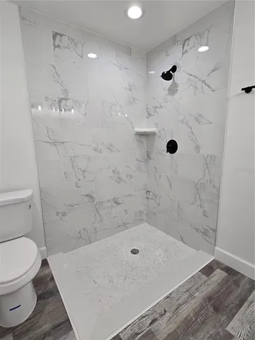 a bathroom with a toilet and shower