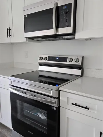 a stove top oven sitting inside of a kitchen