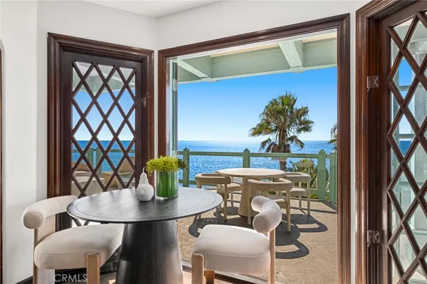 a dining room with furniture and a potted plant