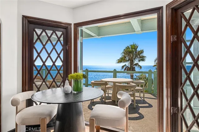 a dining room with furniture and a potted plant