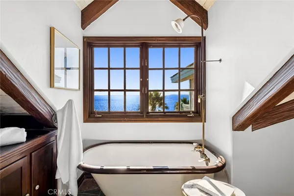 a bath room with a sink furniture and a window