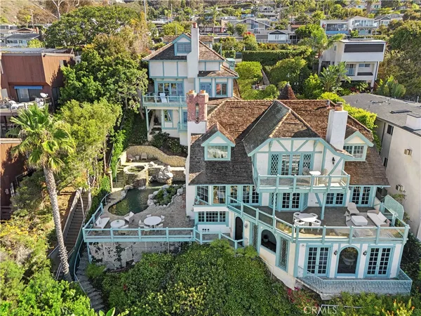 an aerial view of a house with a yard