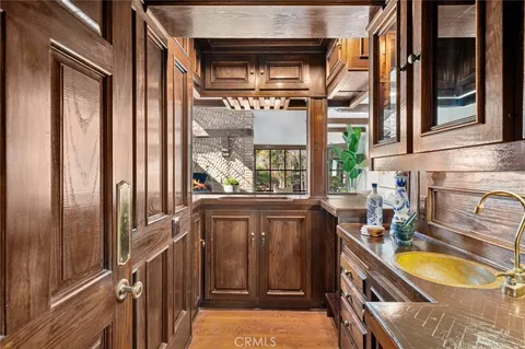 a bathroom with a granite countertop sink and a window