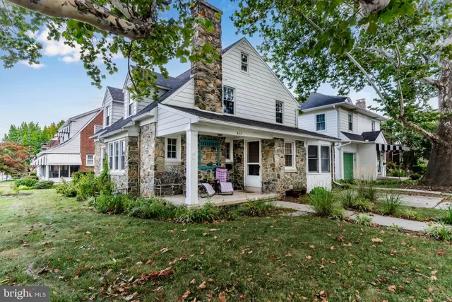 a front view of a house with garden and porch