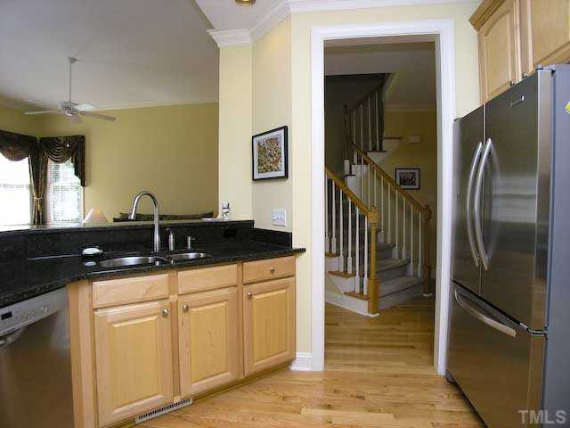 7413 Fontana Ridge Lane Raleigh, NC 27613 - Photo 10 of 25 Extra large refrigerator and walk in pantry complete the updated kitchen.