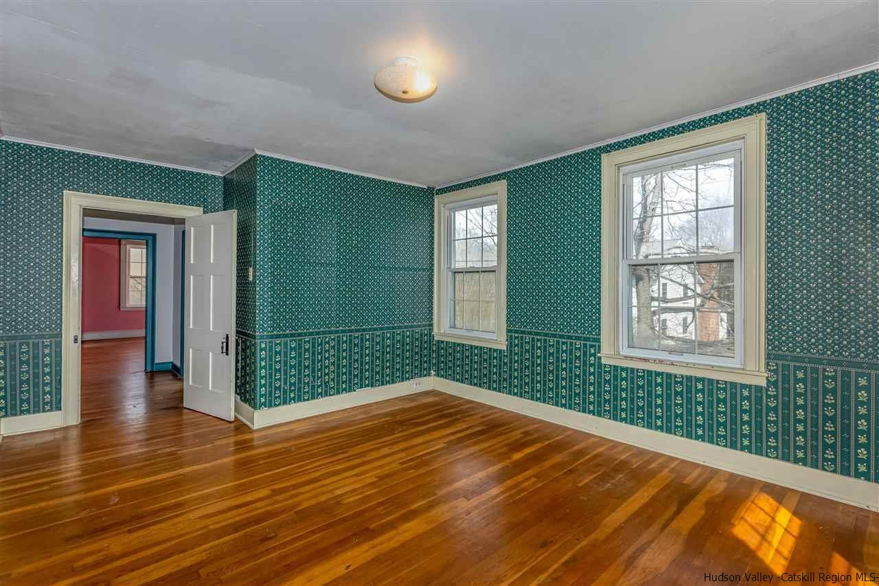 866 Hollow Road Salt Point, NY 12578 - Photo 25 of 32 an empty room with wooden floor and windows