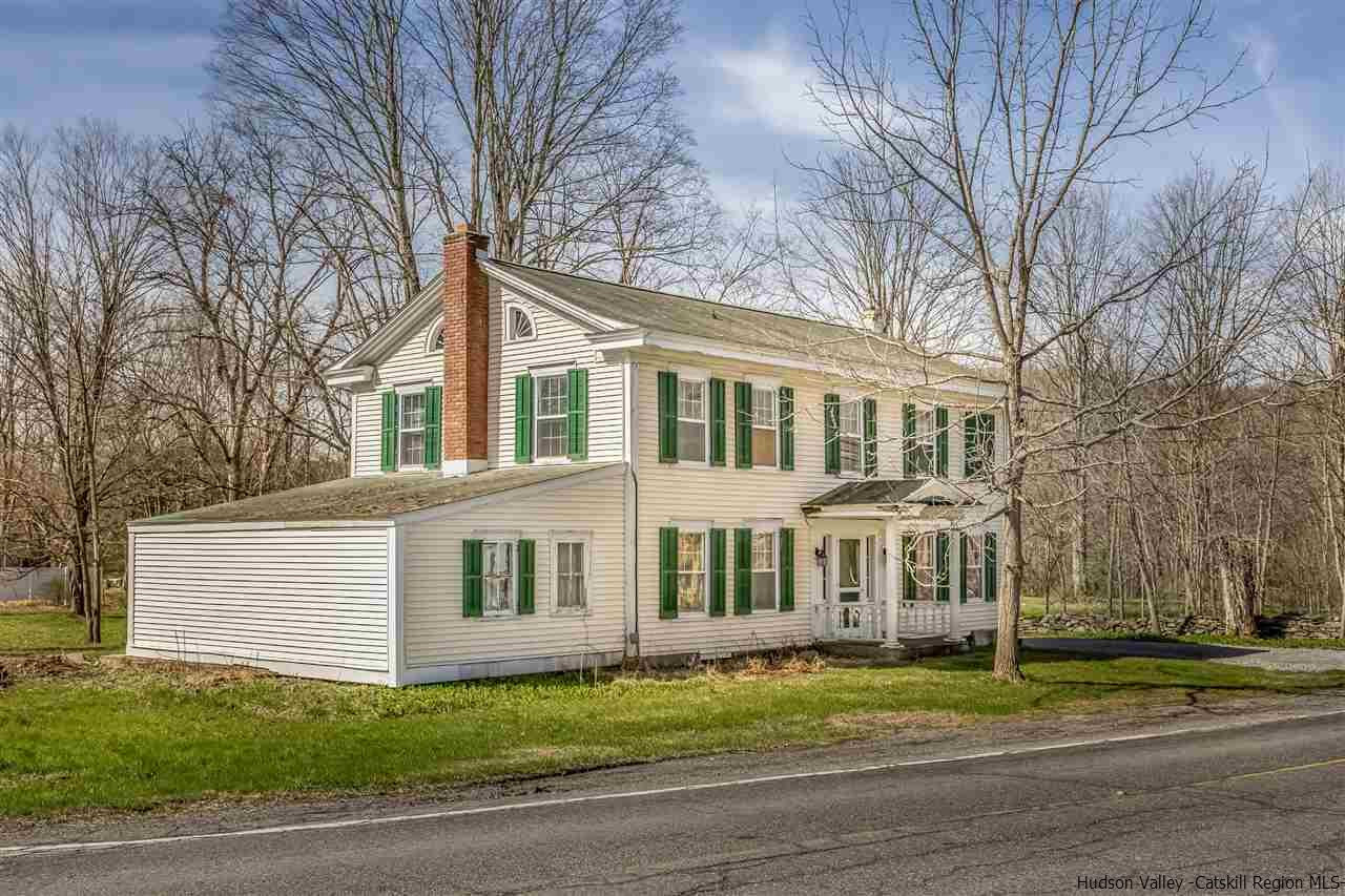 866 Hollow Road Salt Point, NY 12578 - Photo 4 of 32 a view of a white house next to a yard with big trees