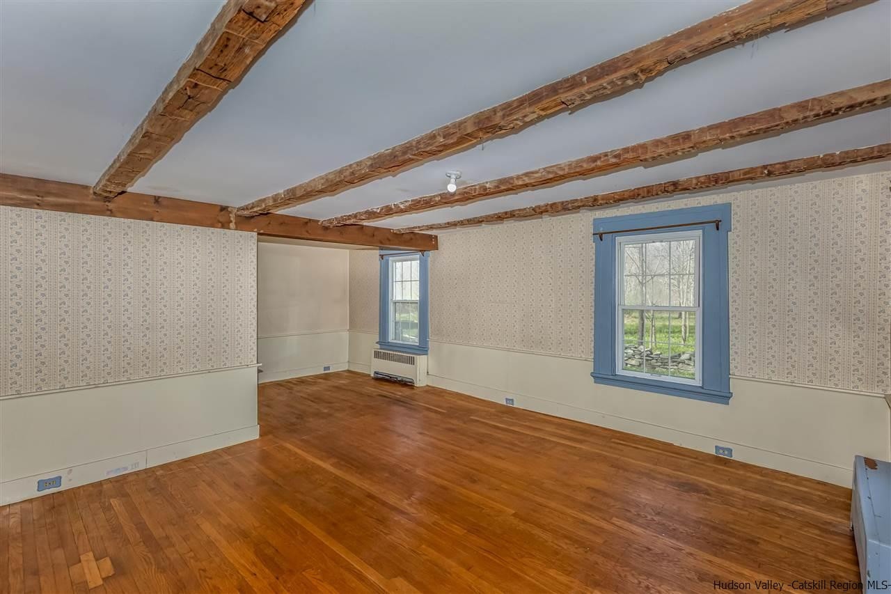 866 Hollow Road Salt Point, NY 12578 - Photo 9 of 32 a view of an empty room with wooden floor and a window