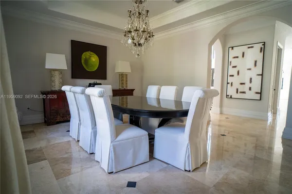 a view of a dining room with furniture and chandelier