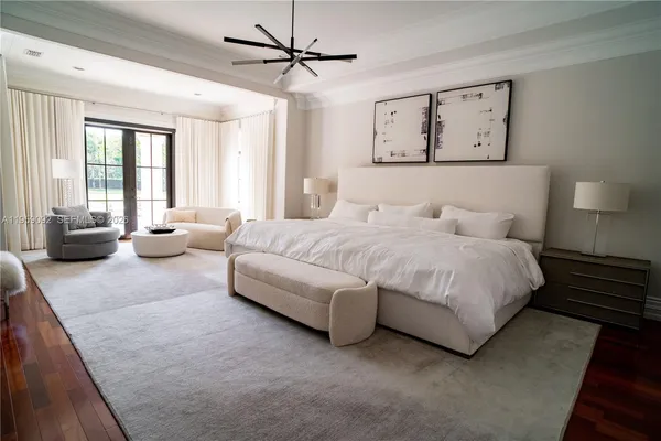 a bedroom with a bed couch and window