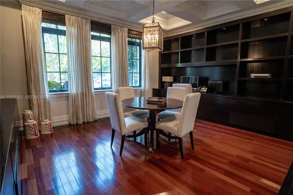 a dining room with furniture and wooden floor