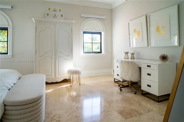 a bedroom with furniture and a window