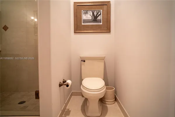 a white toilet sitting next to a bathroom sink