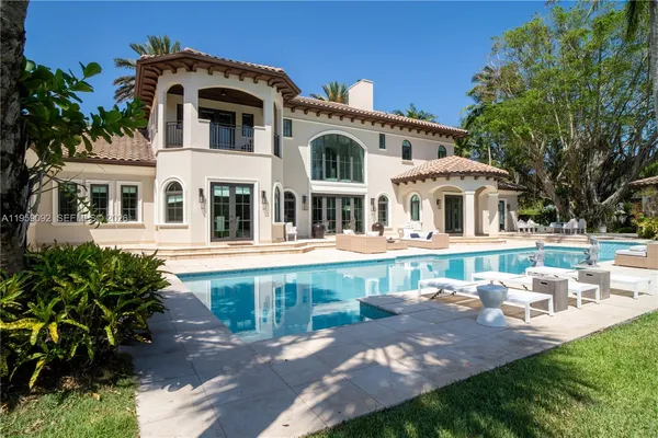 a front view of a house with yard and green space
