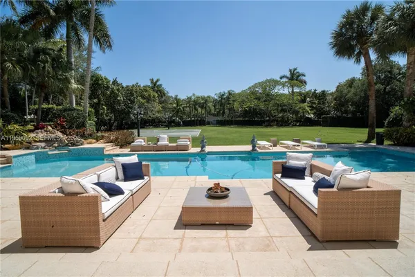 a view of a patio with couches and a table and chairs with garden view