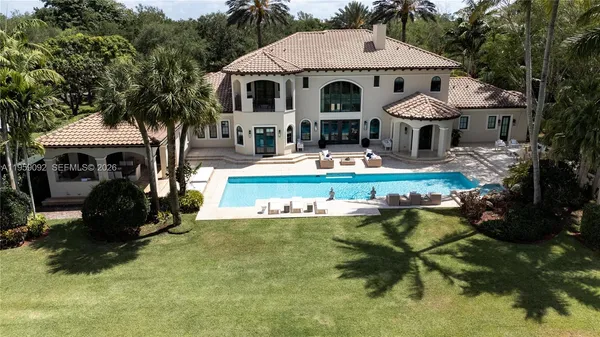 a front view of a house with swimming pool having outdoor seating